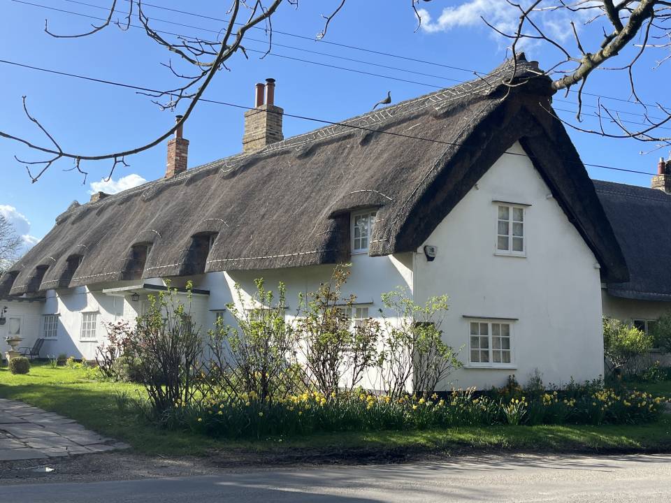 A photograph of a thatched cottage in Meldreth