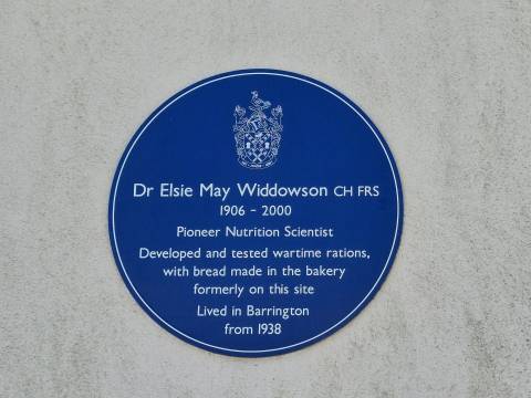 The blue plaque for Dr Elsie May Widdowson. The inscription reads "Developed and tested wartime rations, with bread made in the bakery formerly on this site."