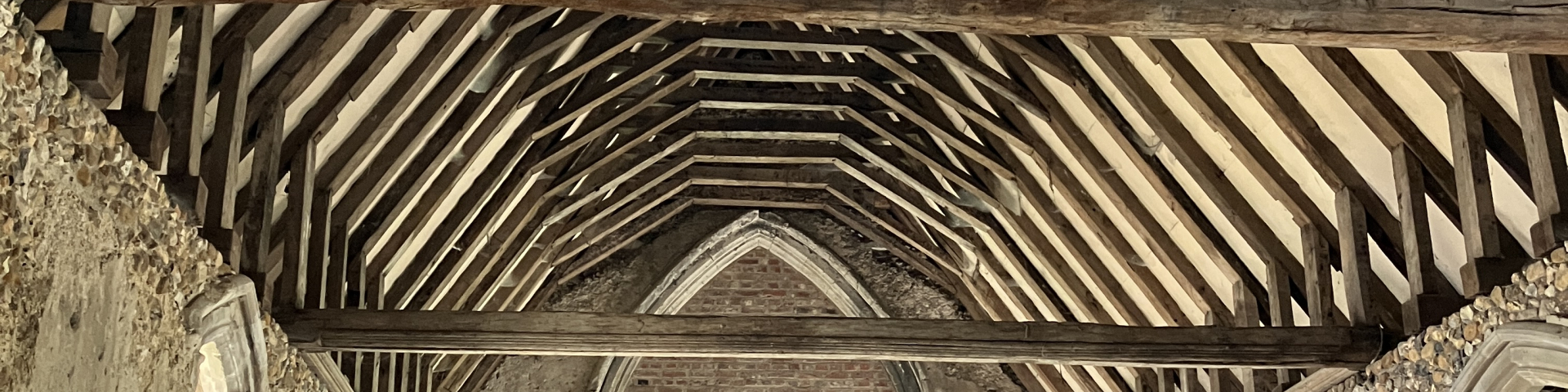 Photograph of the inside of Duxford Chapel showing the roof beams
