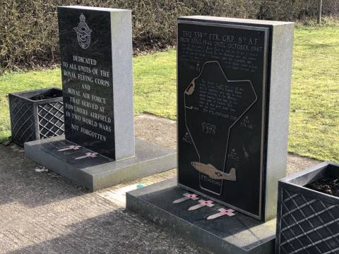 A photograph of two memorial stones at Fowlmere airfield. The left stone says "dedicated to all units of the royal flying corps and royal air force that served at Fowlmere airfield in two world wars. Not forgotten."