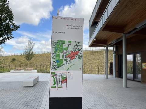 A photograph of a wayfinding post at Cambridge South Station