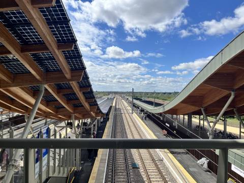 A photograph taken from the footbridge at Cambridge South, looking down onto two of the platforms.