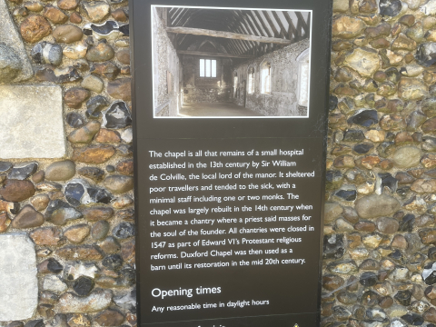 Photograph of the plaque on the outside wall of Duxford Chapel