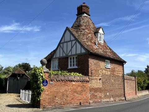 Photograph of Louis Leakey's House in Foxton, showing half timbers and an unusual shaped chimney.