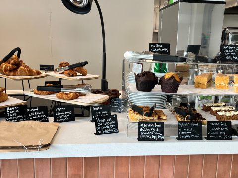 A counter showing cakes for sale. Some are vegan and some gluten free.