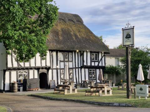 A photograph of the Royal Oak pub in Barrington, featuring a thatched roof and exposed timbers.