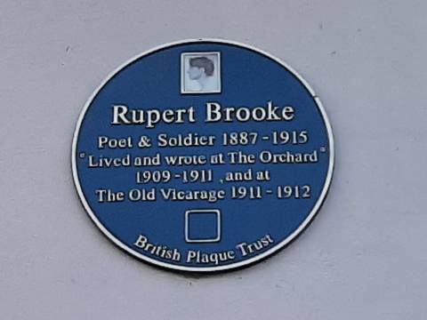 Photograph of the blue plaque to Rupert Brooke. The inscription reads "Lived and wrote at The Orchard 1909-1911 and at The Old Vicarage 1911-1912."