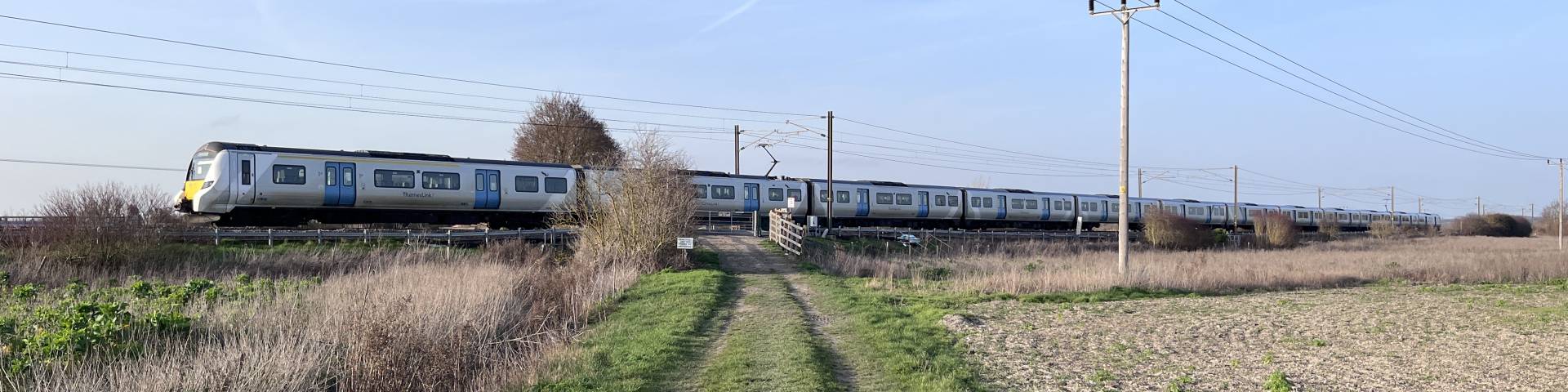 Photograph of a Thameslink train going across a foot crossing.