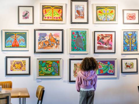 A photograph of a child examining paintings at Stapleford Granary