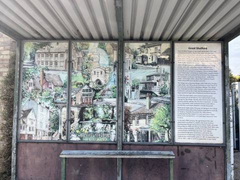 A photograph of a bus shelter in Great Shelford. There are paintings of Shelford landmarks and a short history of the village